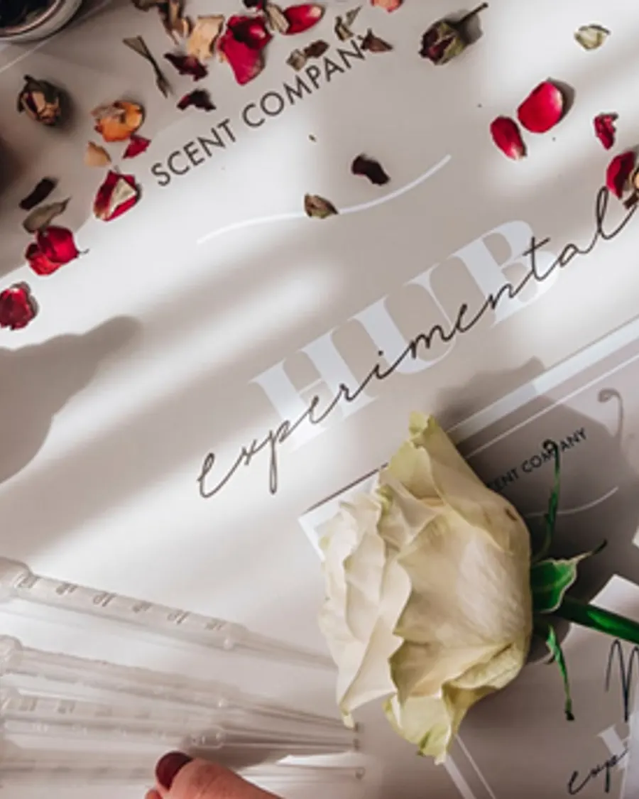 A perfumer's flat-lay workspace with fragrance vials, evoking the Florence atelier